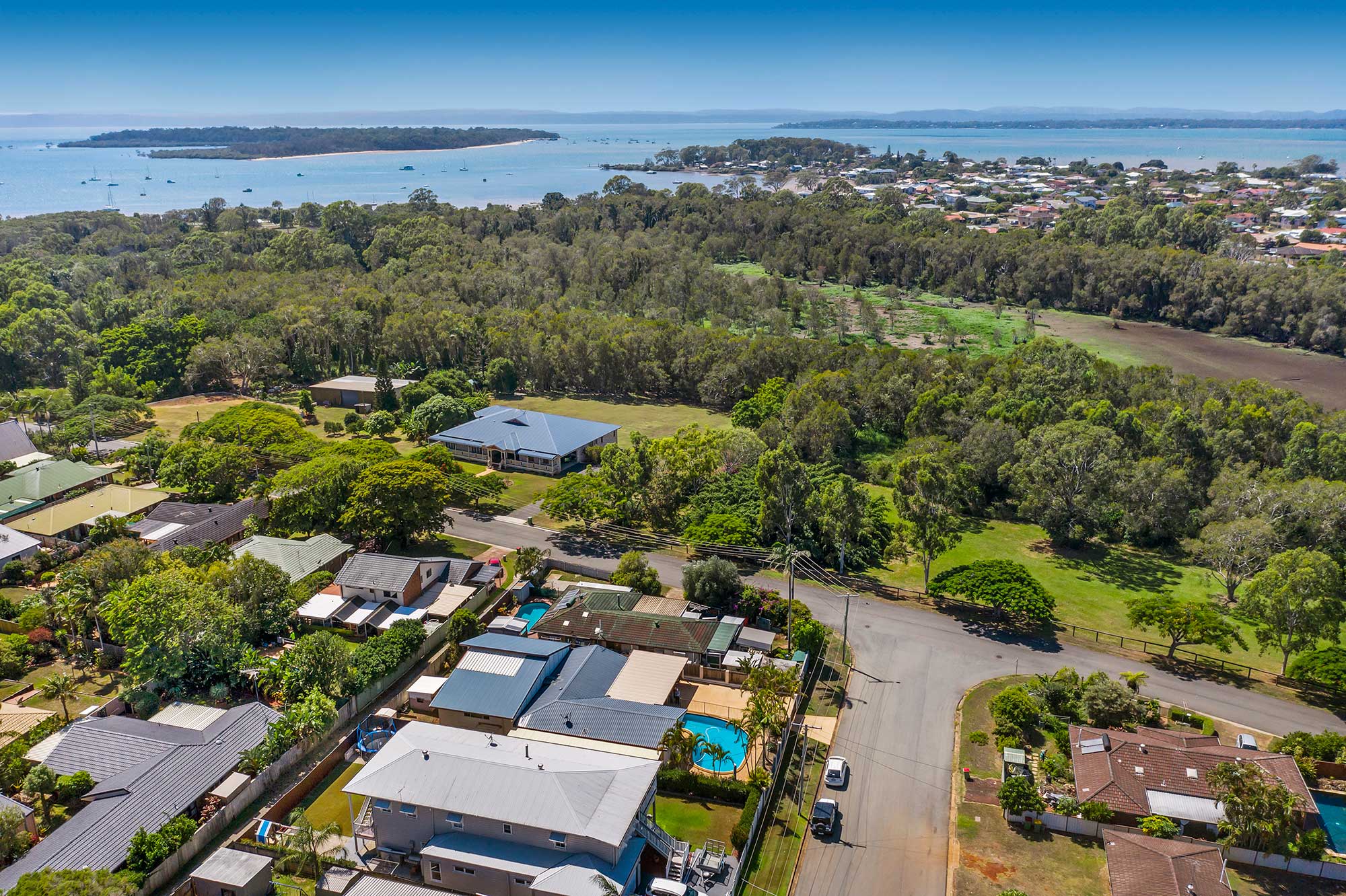 Drone photography of home for sale at Victoria Point highlighting proximity to Morton Bay