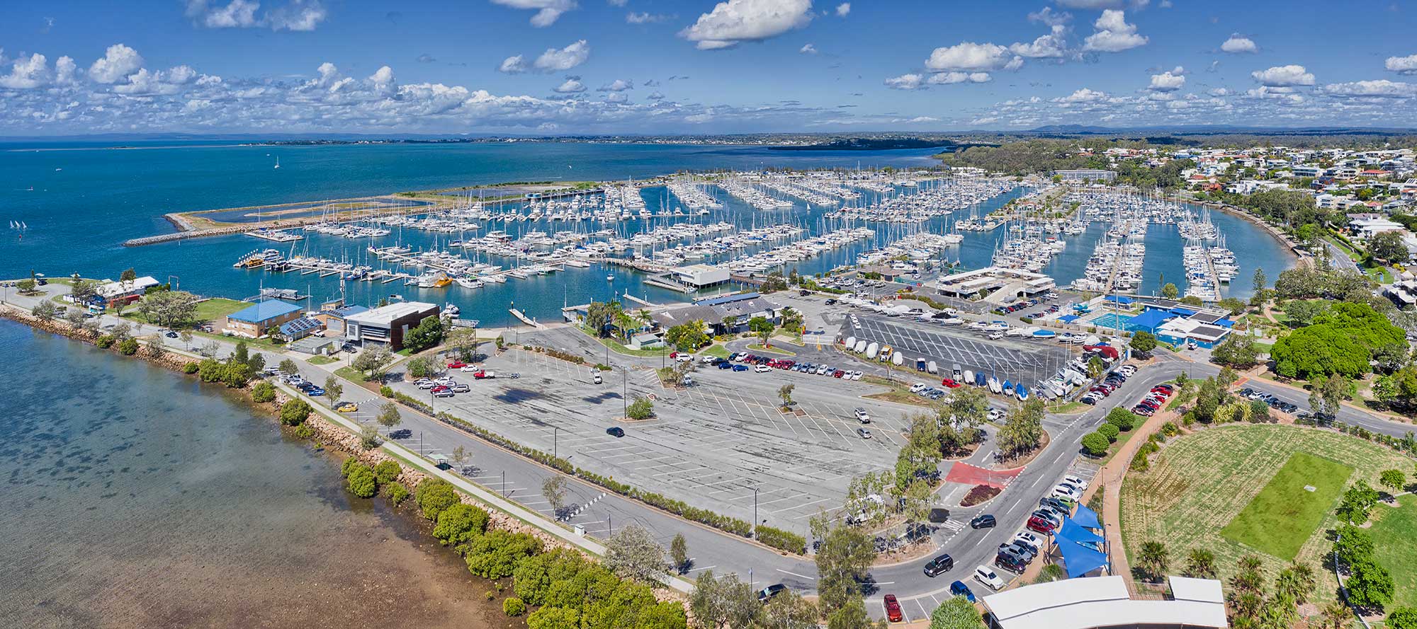 Drone photography Manly Boat Club and Marina with Redland Bay in the background Drone photography Manly Boat Club and Marina with Redland Bay in the background