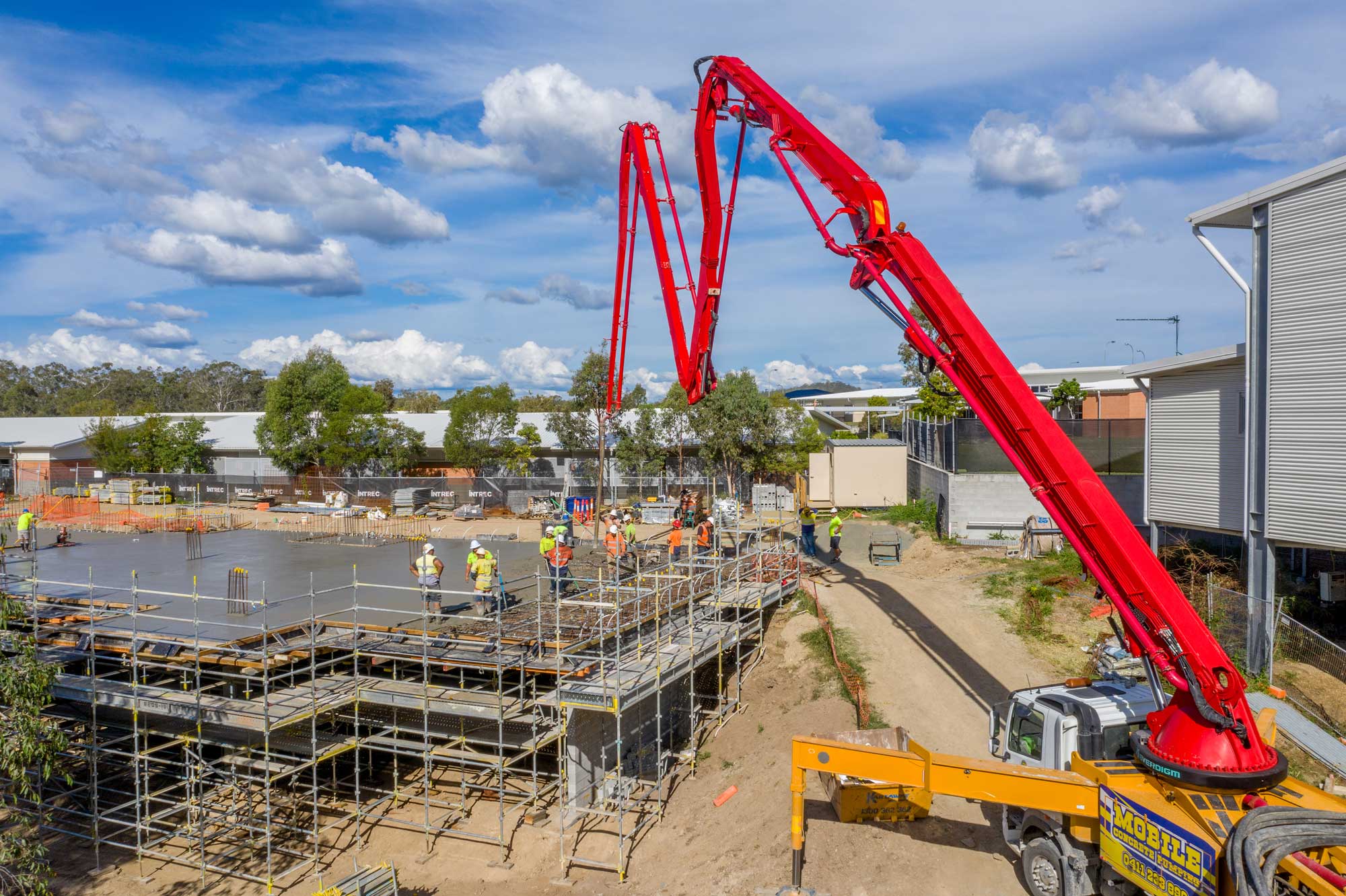 The Mavic2Pro captures the 40m concrete line and boom pump hovering at 5 metres above the ground - Augusta State School concrete slab pour